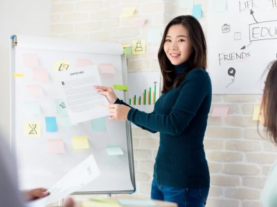 Young Asian woman college teacher teaching students in classroom